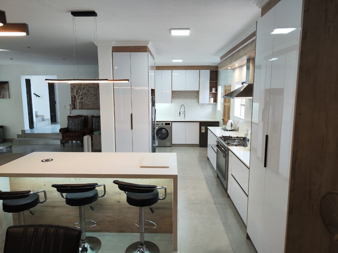 Bright white gloss kitchen with oak trim